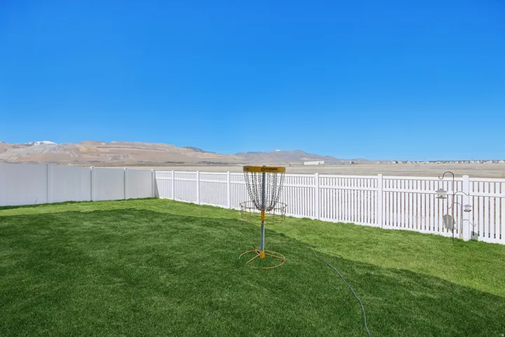 Fenced backyard featuring a mountain view