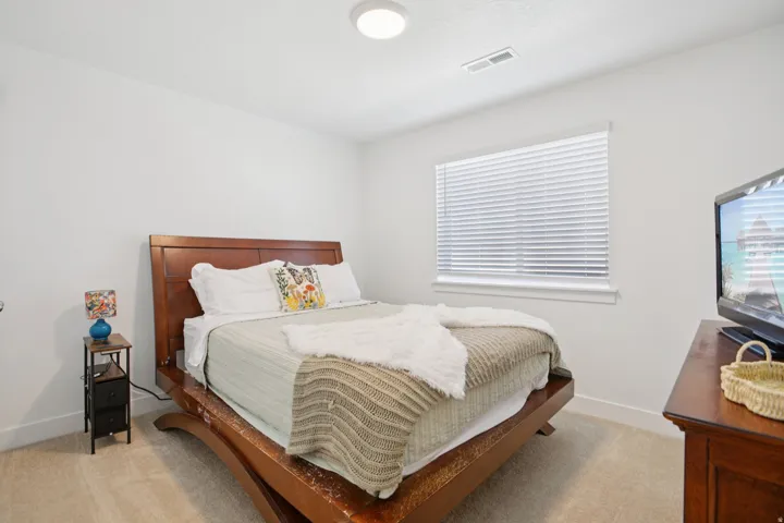 Bedroom with light colored carpet