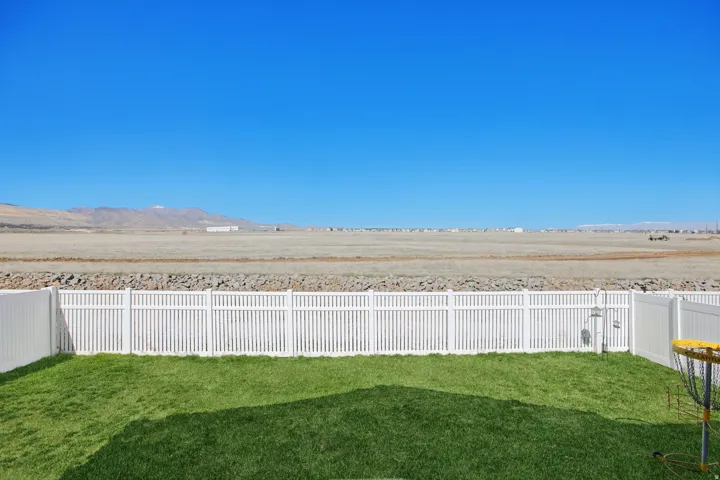 Fenced backyard featuring a mountain view