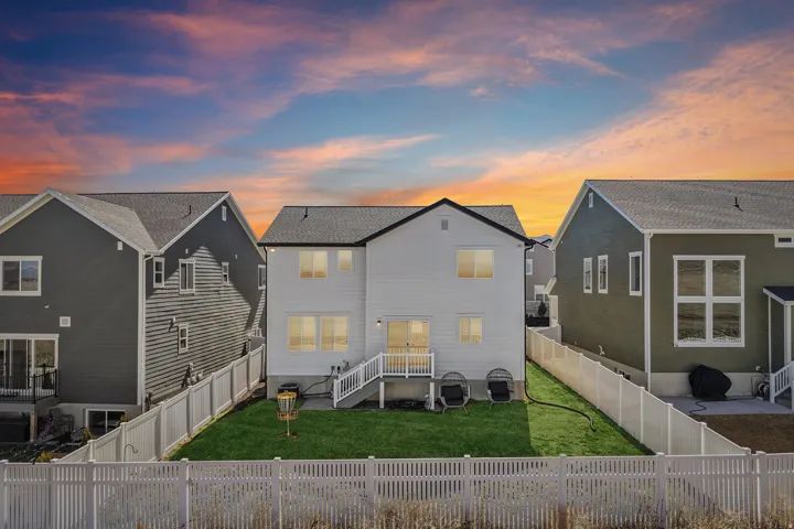 Rear view of property with a fenced backyard