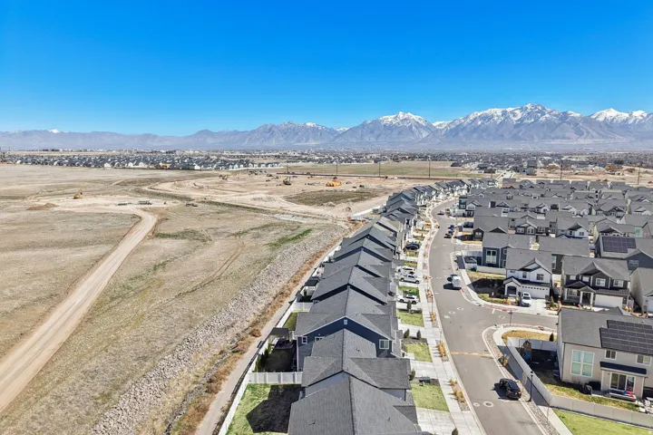 Aerial perspective of suburban area featuring a mountain backdrop