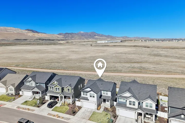Aerial perspective of suburban area featuring a mountainous background