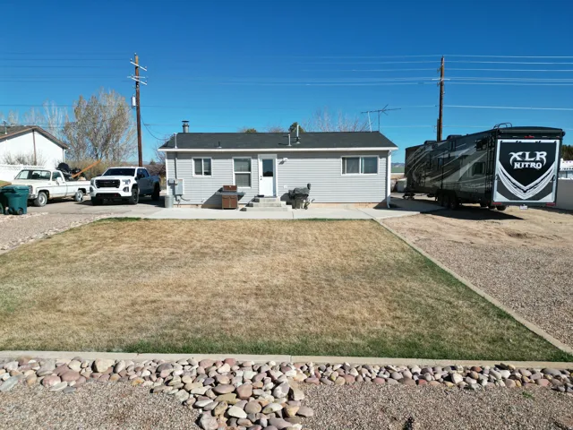 Single story home featuring a back yard, a patio, and entry steps