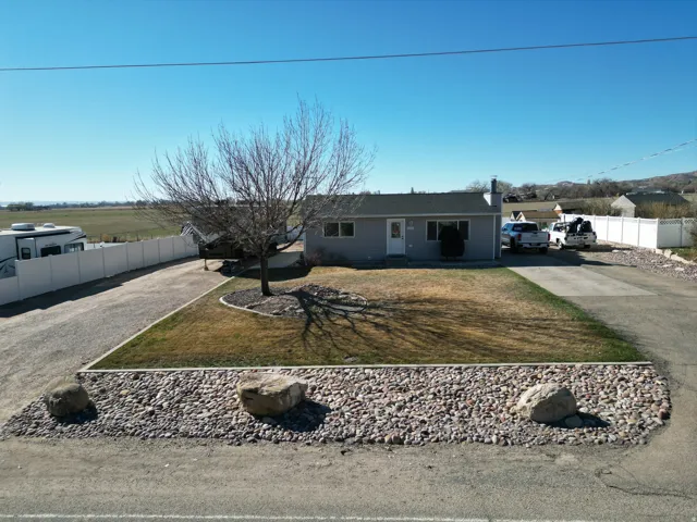 Single story home featuring driveway and a chimney
