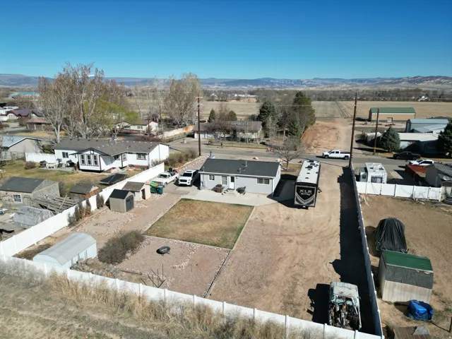 Aerial view of residential back yard area featuring mountains