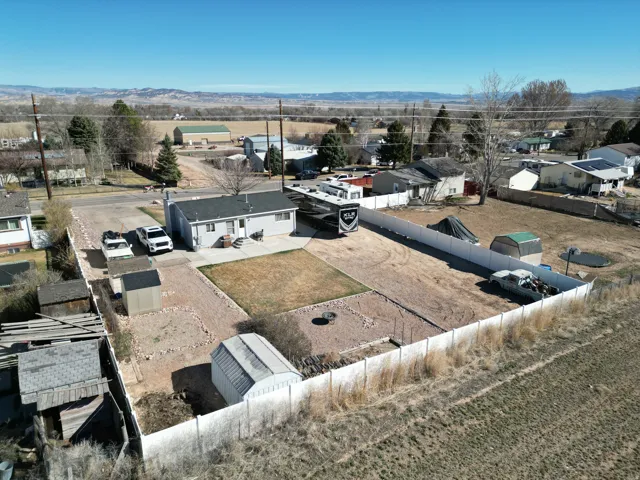 Aerial view of residential backyard area with a mountain backdrop