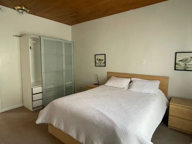 Carpeted bedroom with wooden ceiling