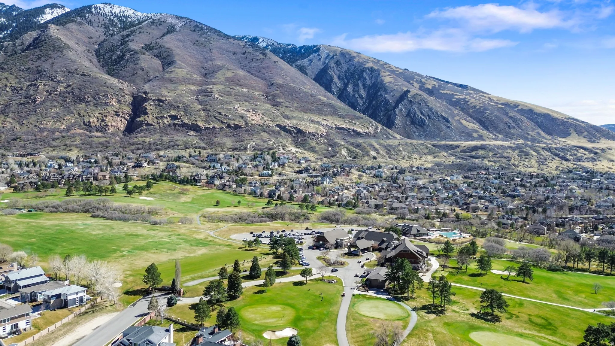 Mountain view with nearby suburban area and a golf club