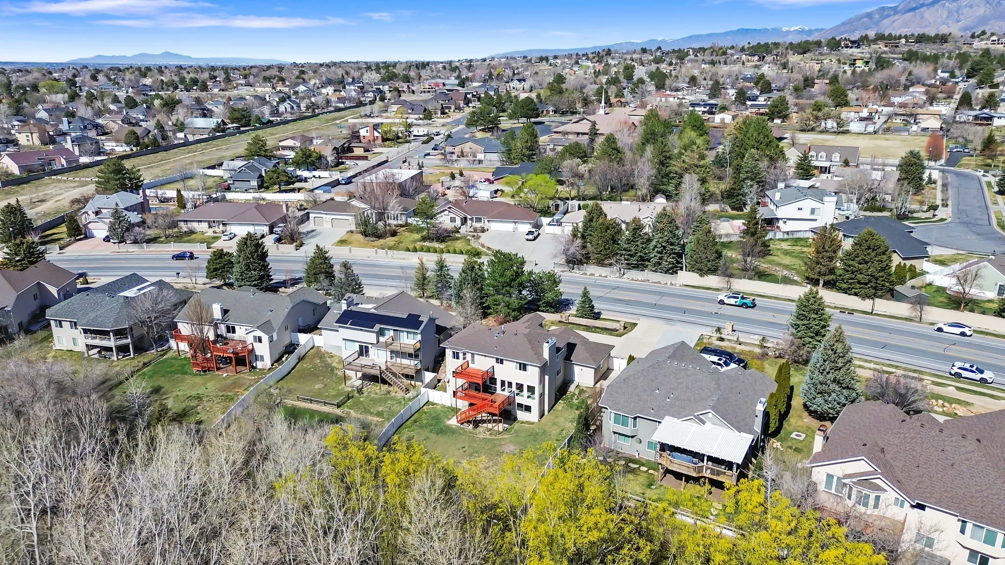 Aerial perspective of suburban area with a mountain backdrop