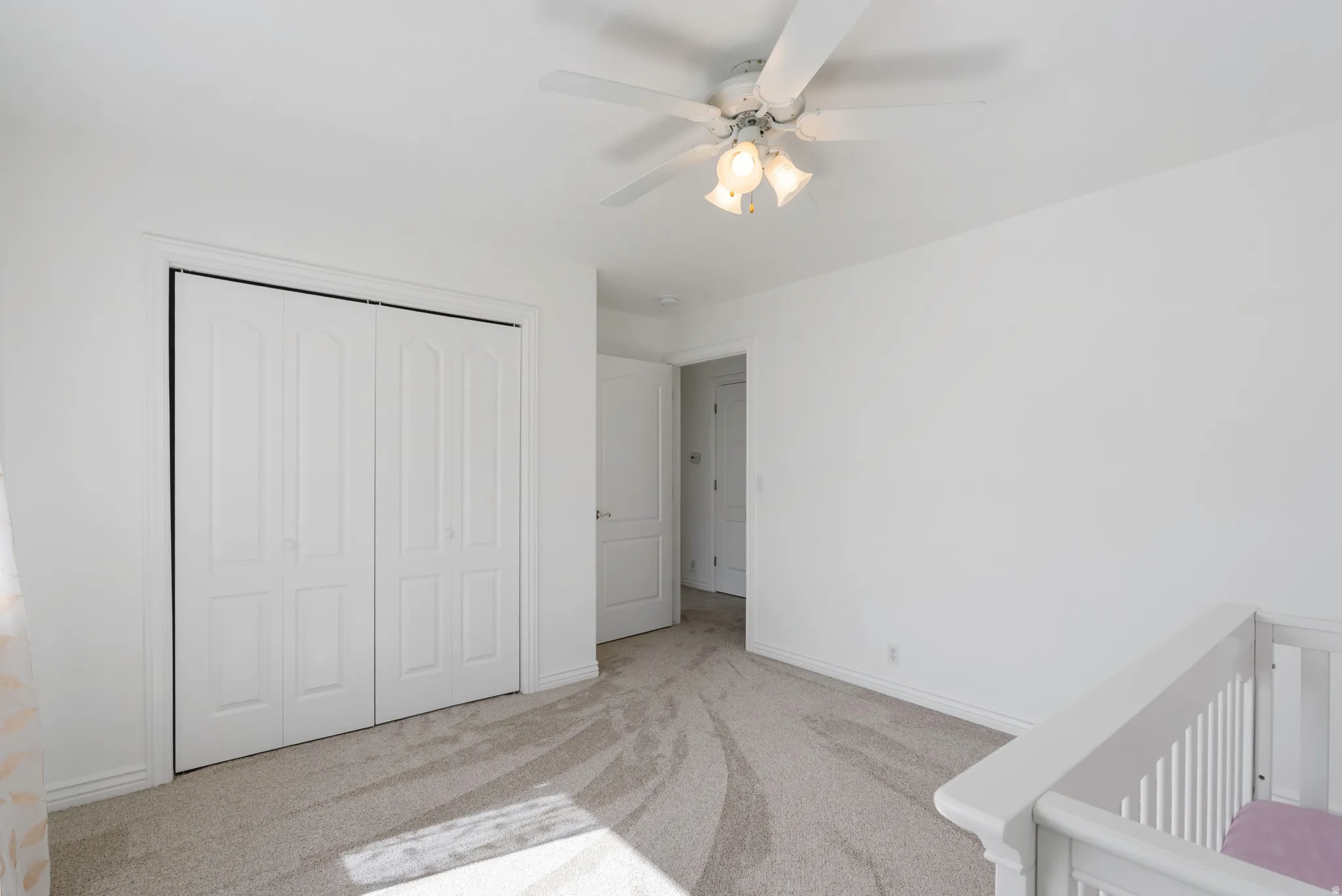 Unfurnished bedroom with carpet floors, a closet, and ceiling fan