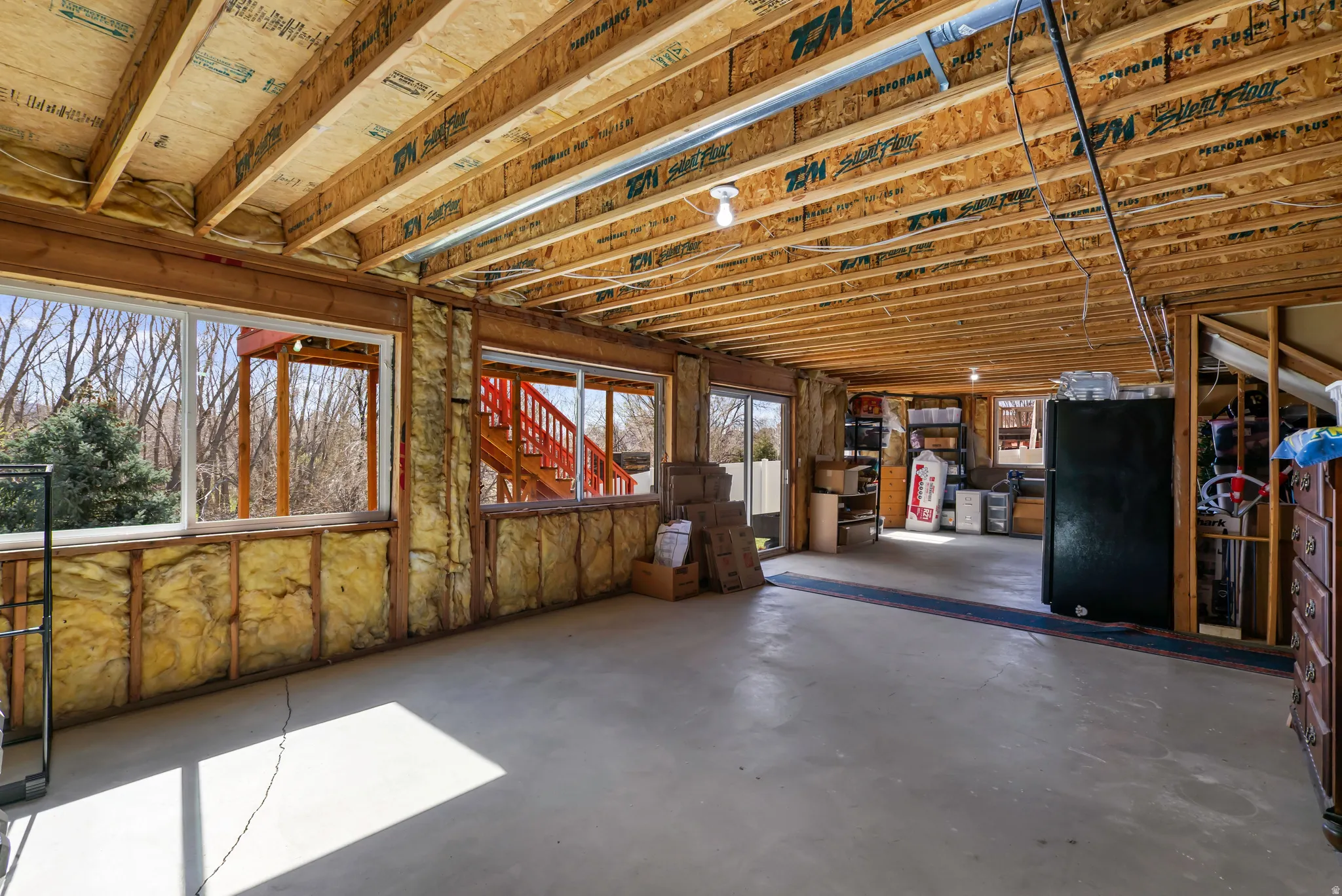 Basement featuring freestanding refrigerator
