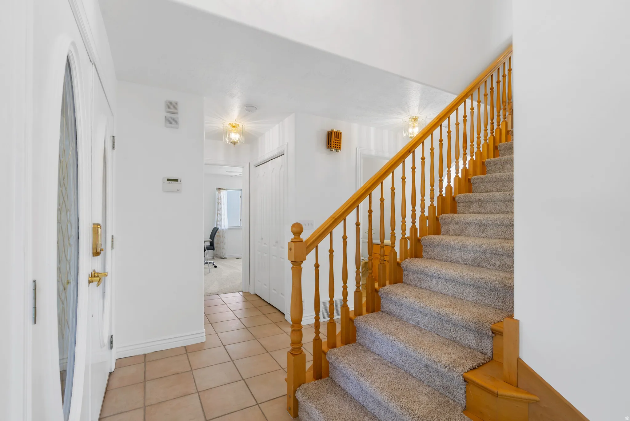 Staircase featuring baseboards and tile patterned flooring