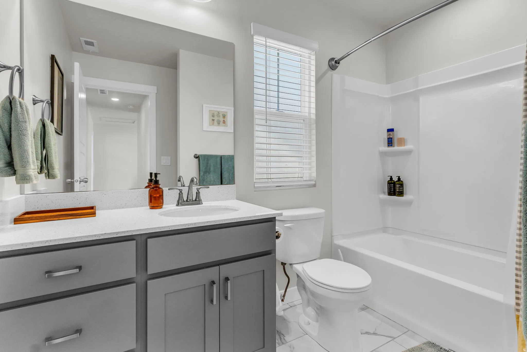Full bath featuring vanity and shower / bathtub combination