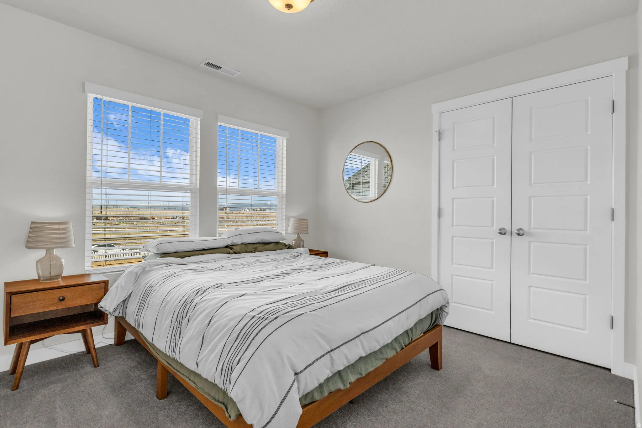 Carpeted bedroom with a closet