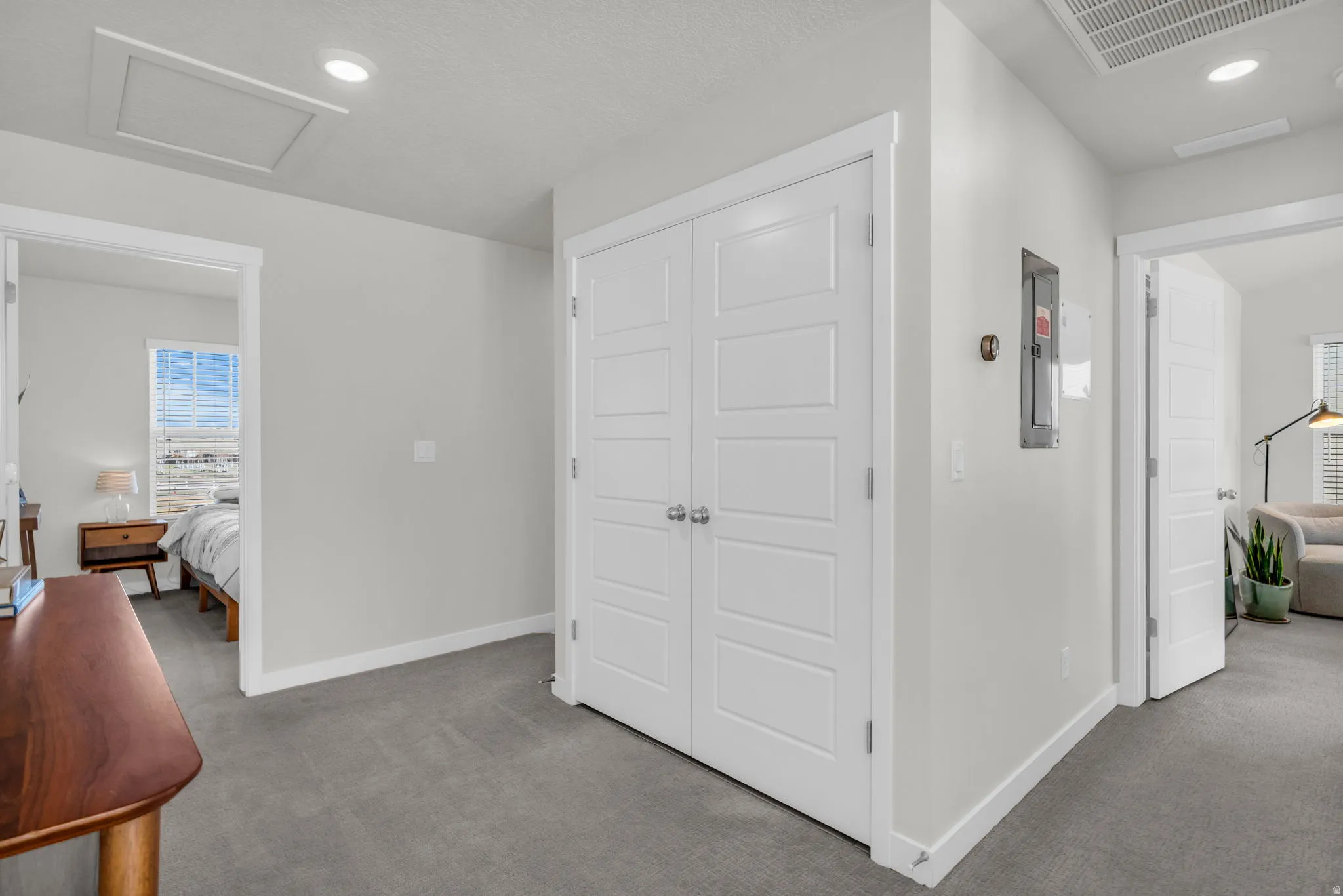 Corridor featuring carpet floors, recessed lighting, and electric panel
