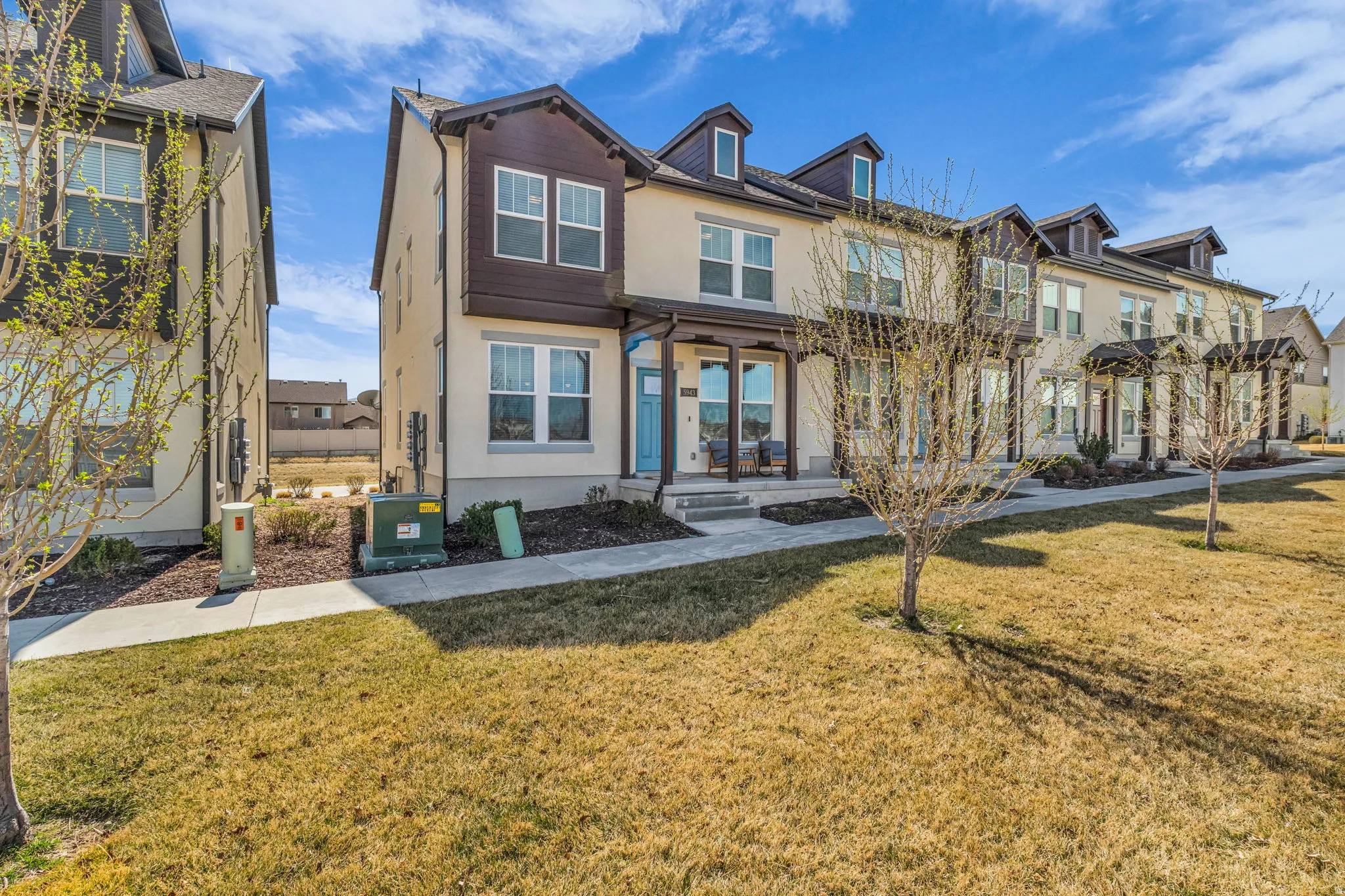 Traditional home with stucco siding and a front yard