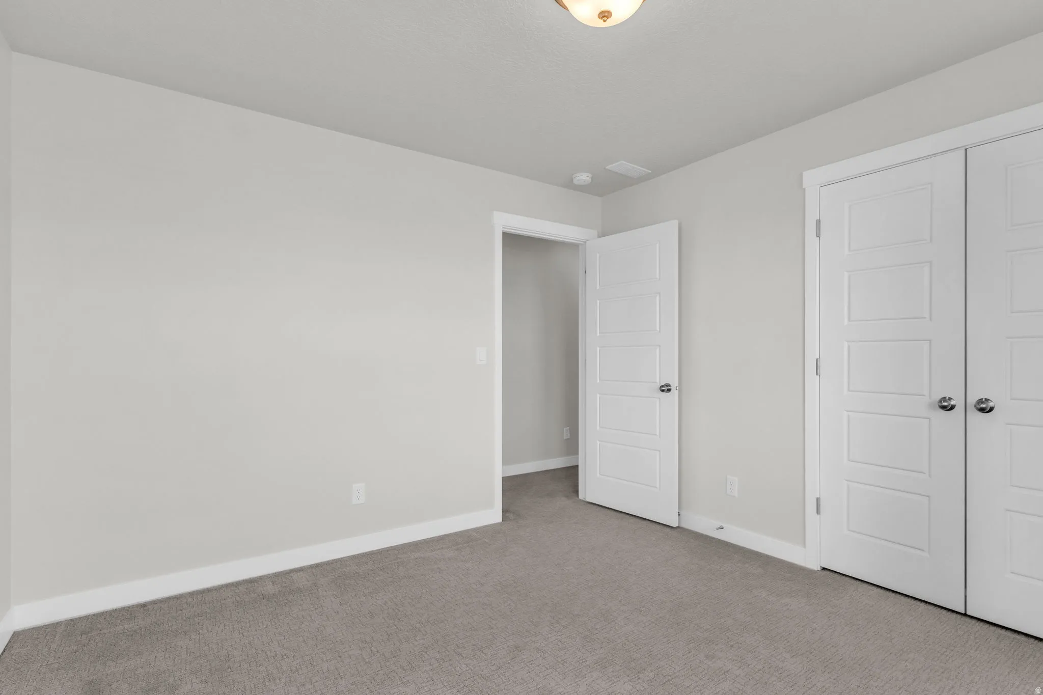 Unfurnished bedroom with carpet floors and a closet
