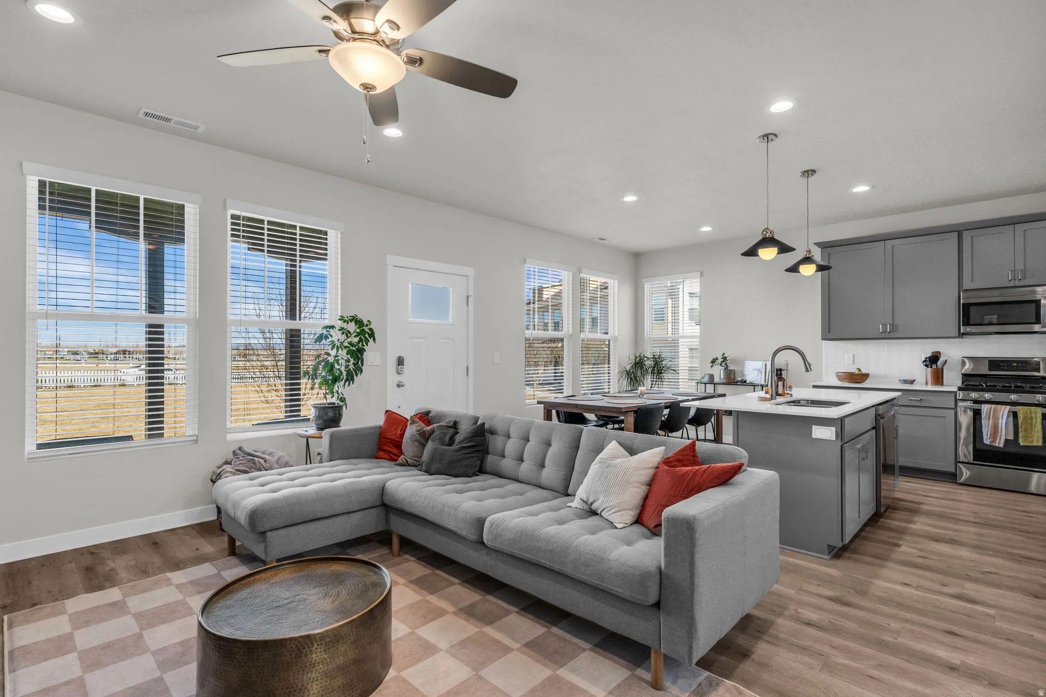 Living area featuring recessed lighting, light wood finished floors, and a ceiling fan