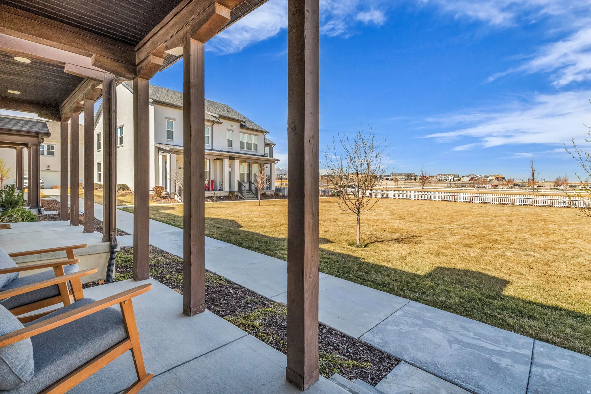 Covered porch featuring a residential view