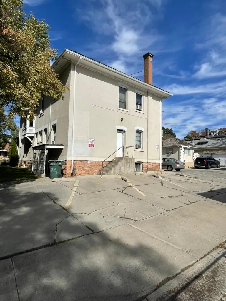 View of building exterior with uncovered parking
