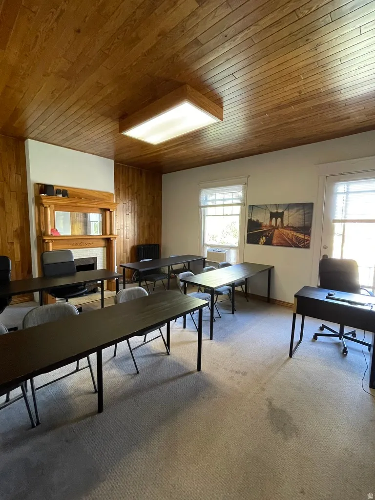 Game room with healthy amount of natural light, wood ceiling, and an office area
