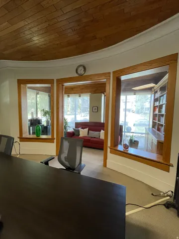 Office space with wooden ceiling and carpet floors