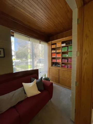 Sitting room with carpet flooring and wood ceiling