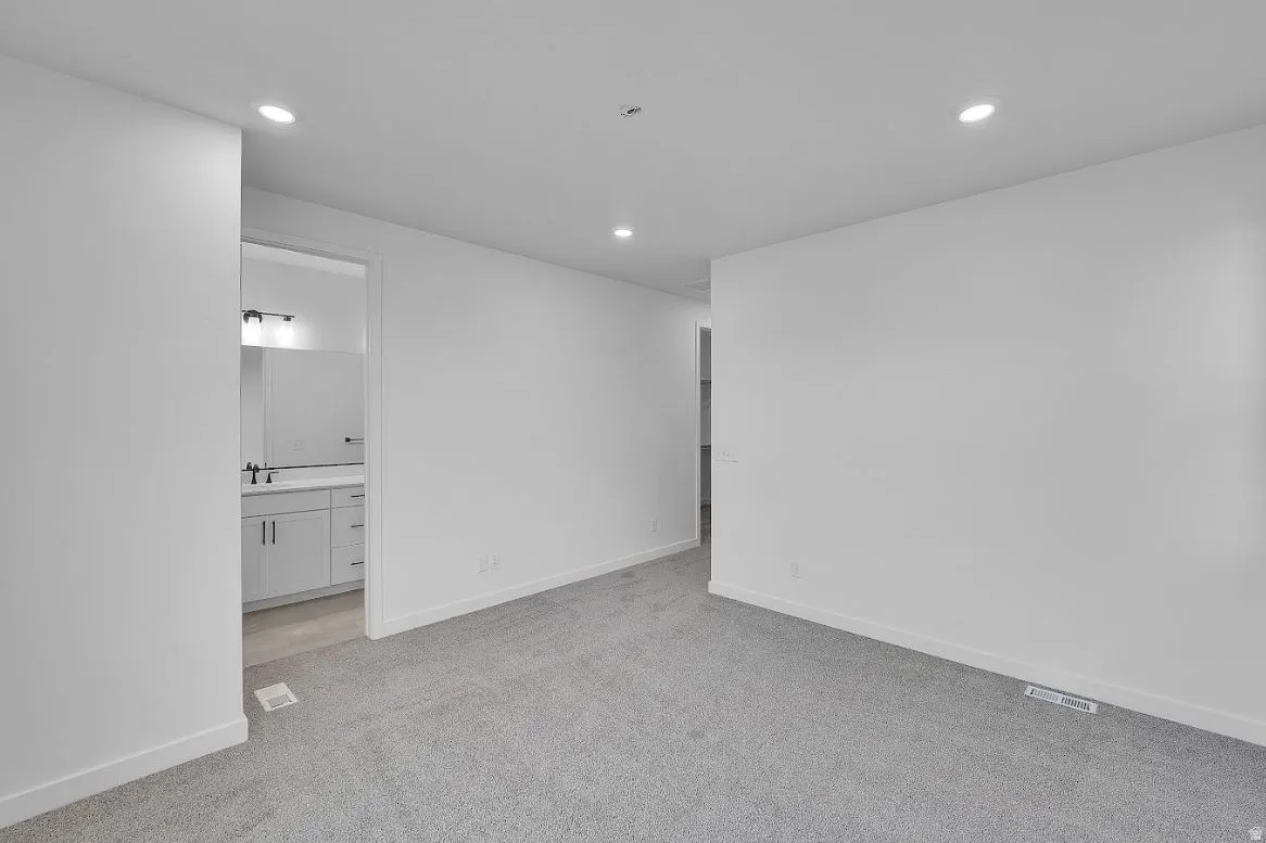 Unfurnished room featuring light colored carpet and recessed lighting
