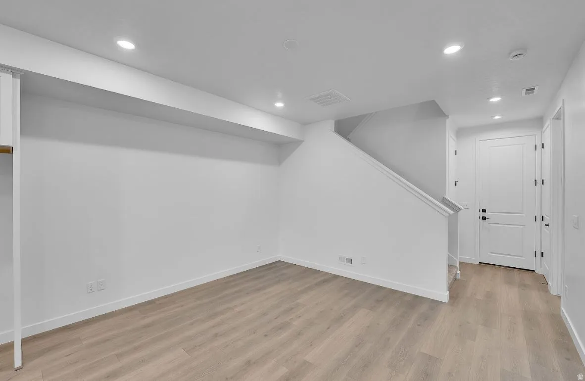 Finished basement featuring recessed lighting and light wood finished floors