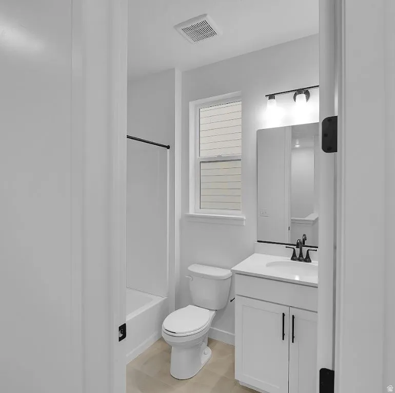 Bathroom featuring vanity and shower / bath combination
