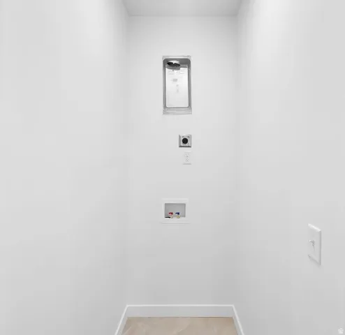 Laundry room with hookup for an electric dryer and hookup for a washing machine