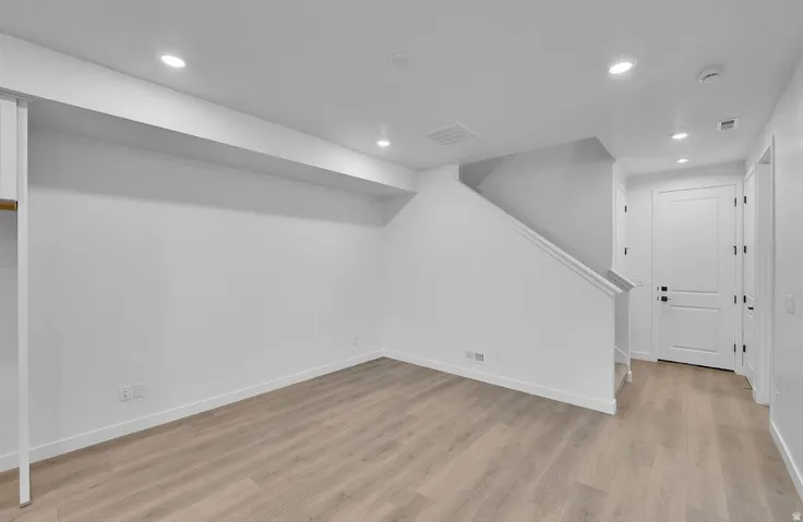 Finished basement featuring recessed lighting and light wood finished floors