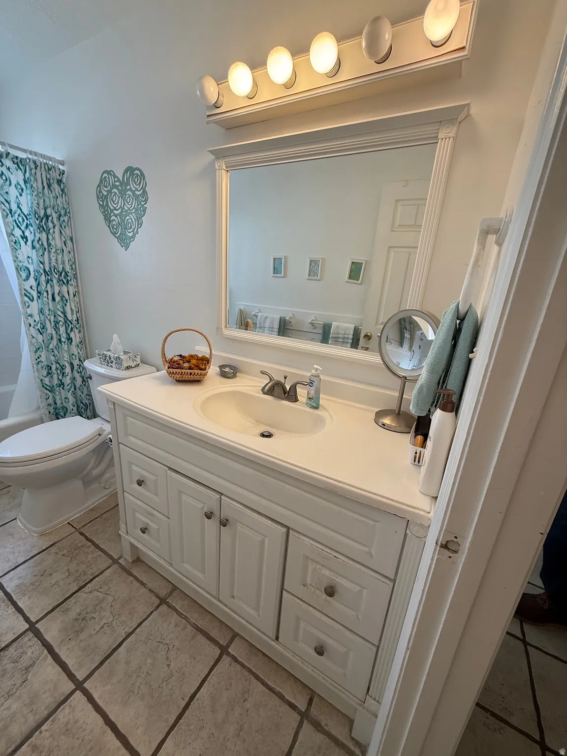 Full bath featuring vanity and shower / bath combination with curtain