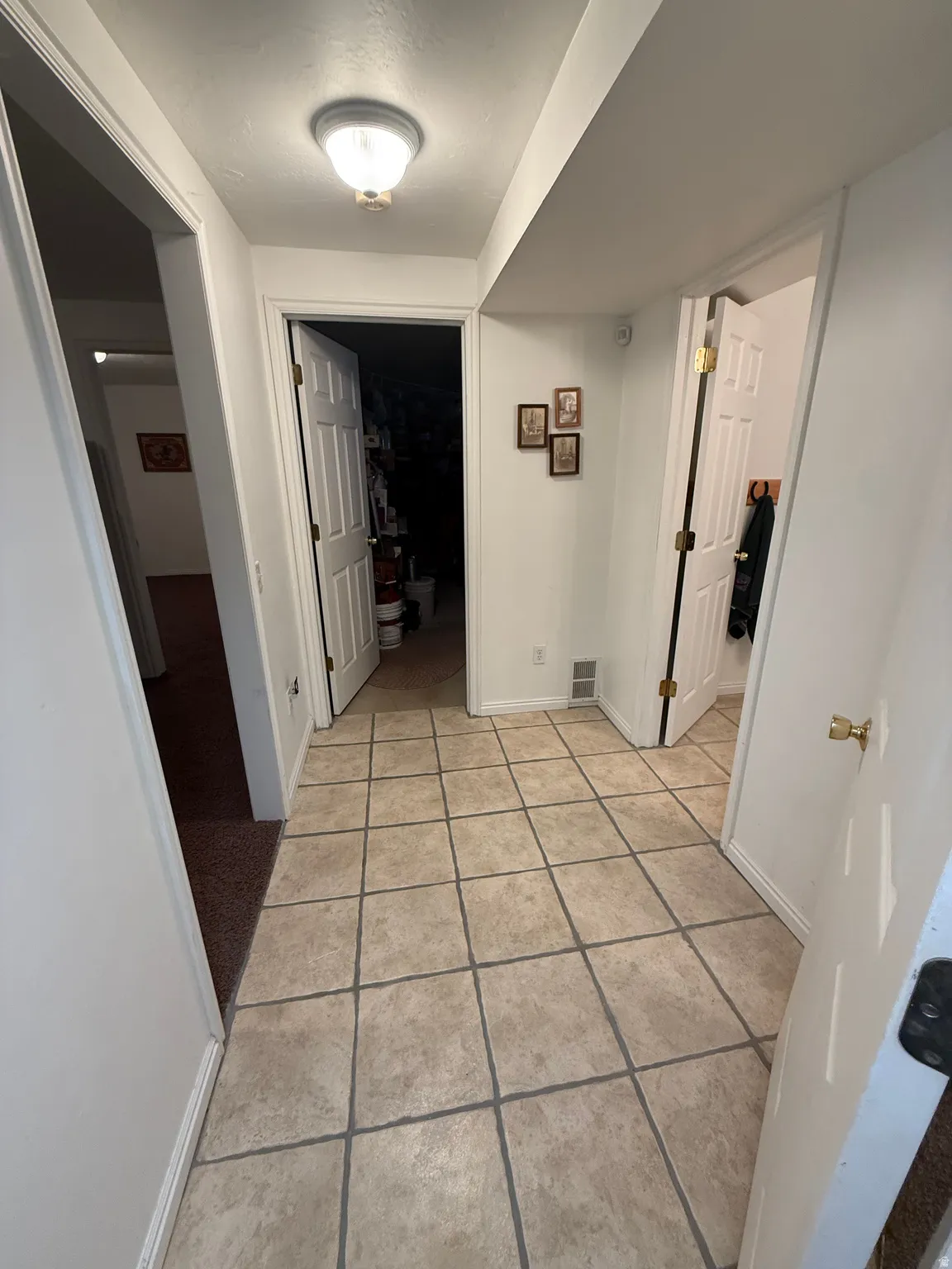 Hall with baseboards and light tile patterned floors