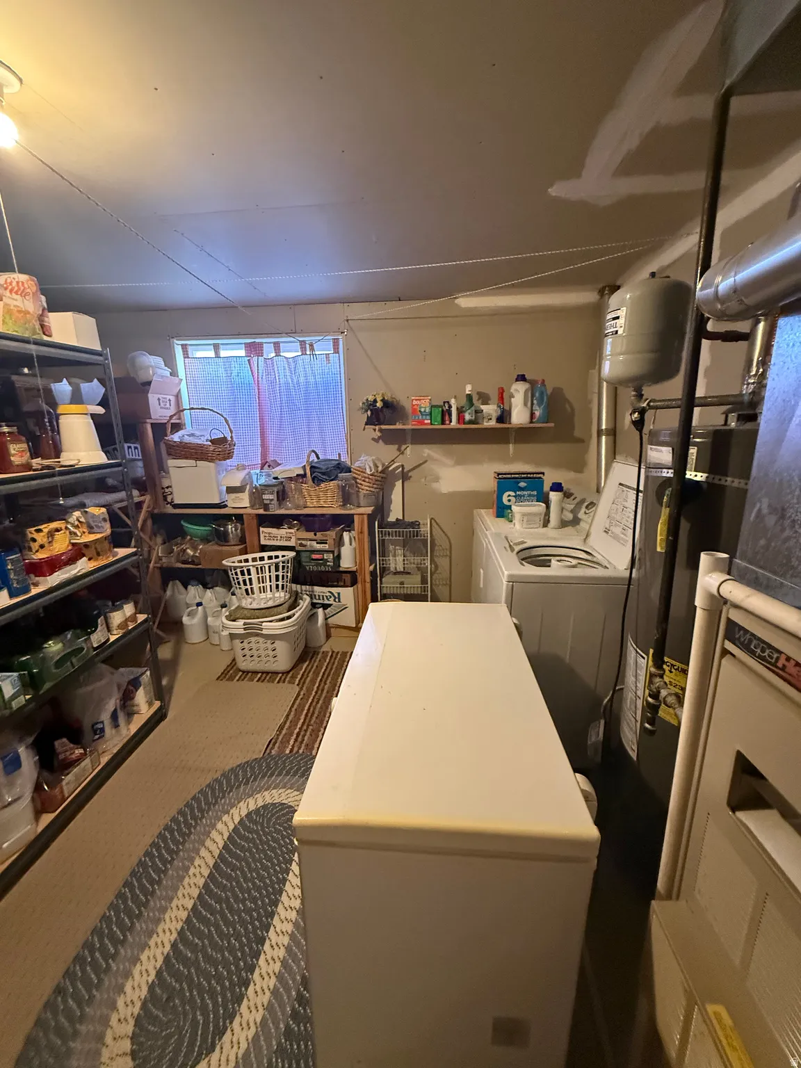Basement with gas water heater and independent washer and dryer