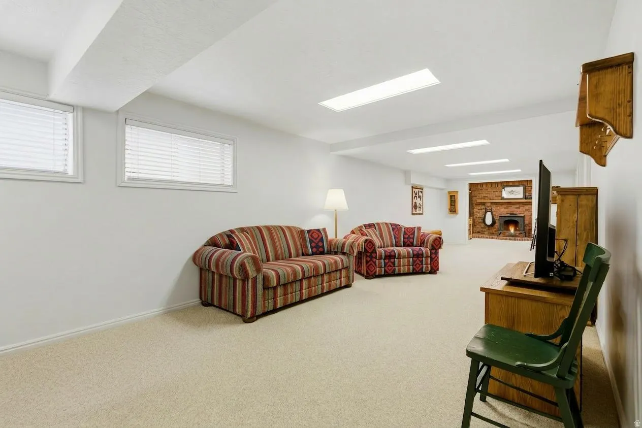 Carpeted living area featuring baseboards
