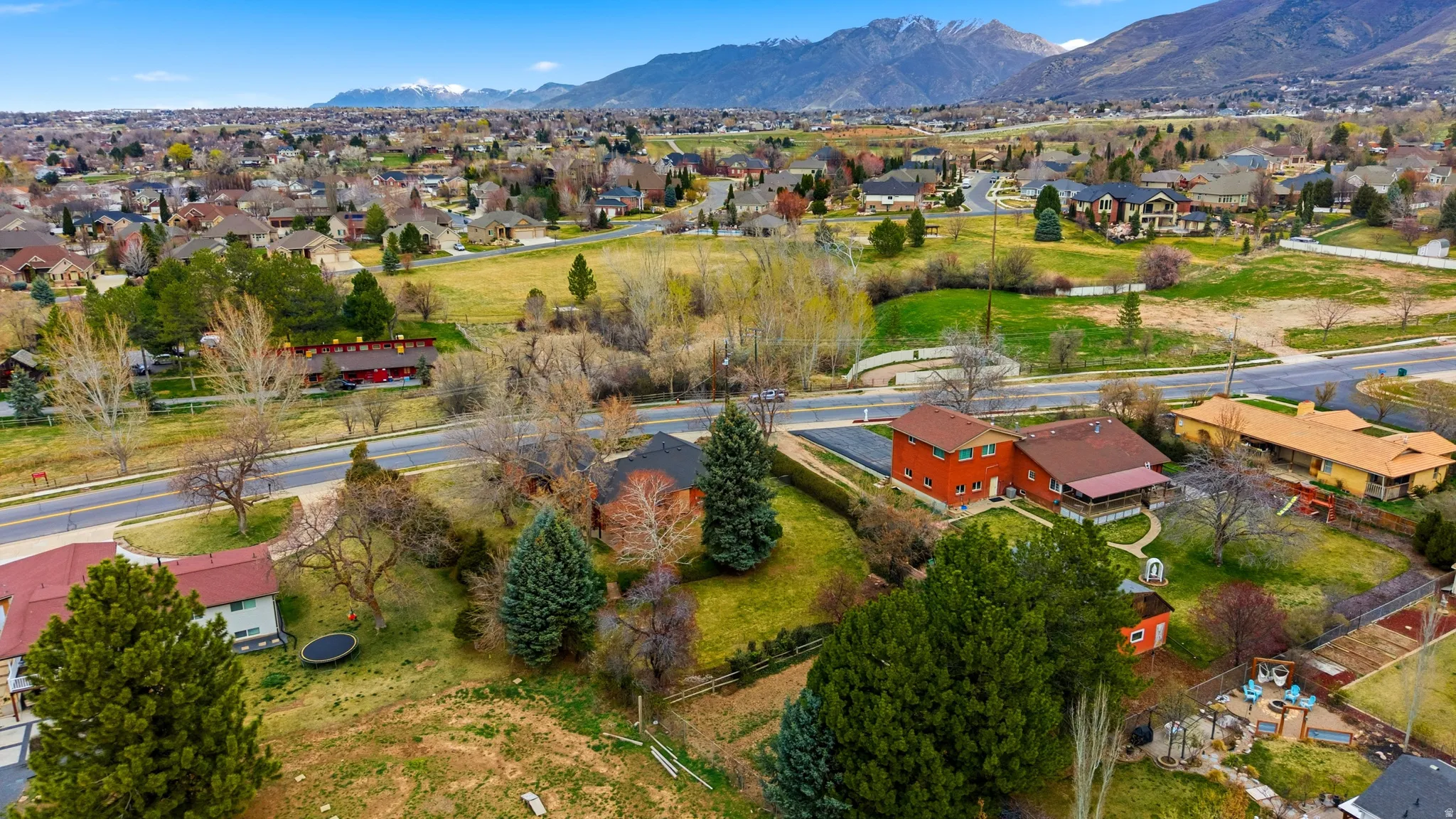 Aerial perspective of suburban area featuring a mountain backdrop