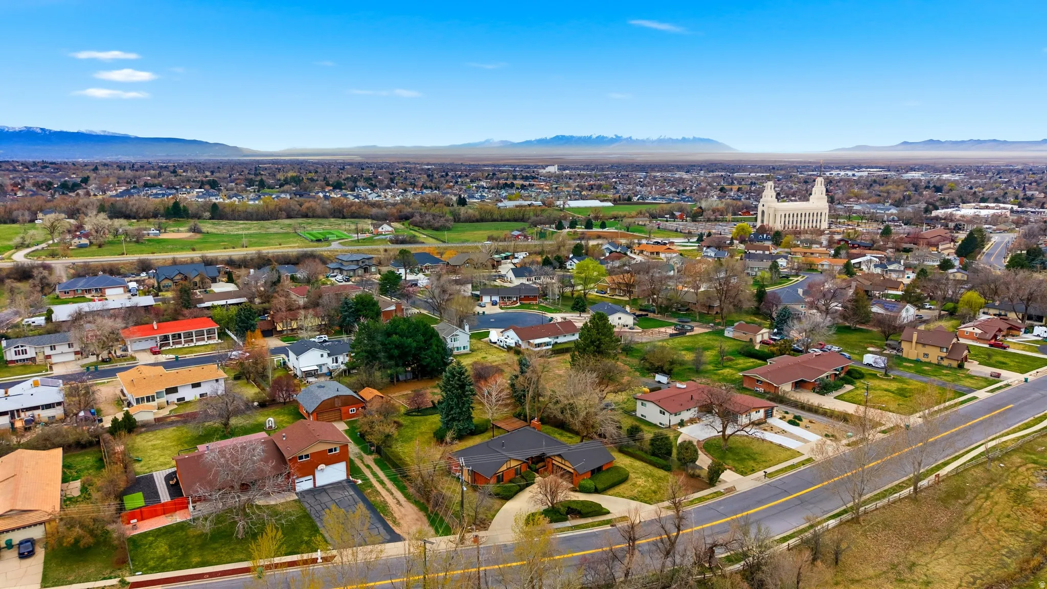 Aerial perspective of suburban area with a mountain backdrop