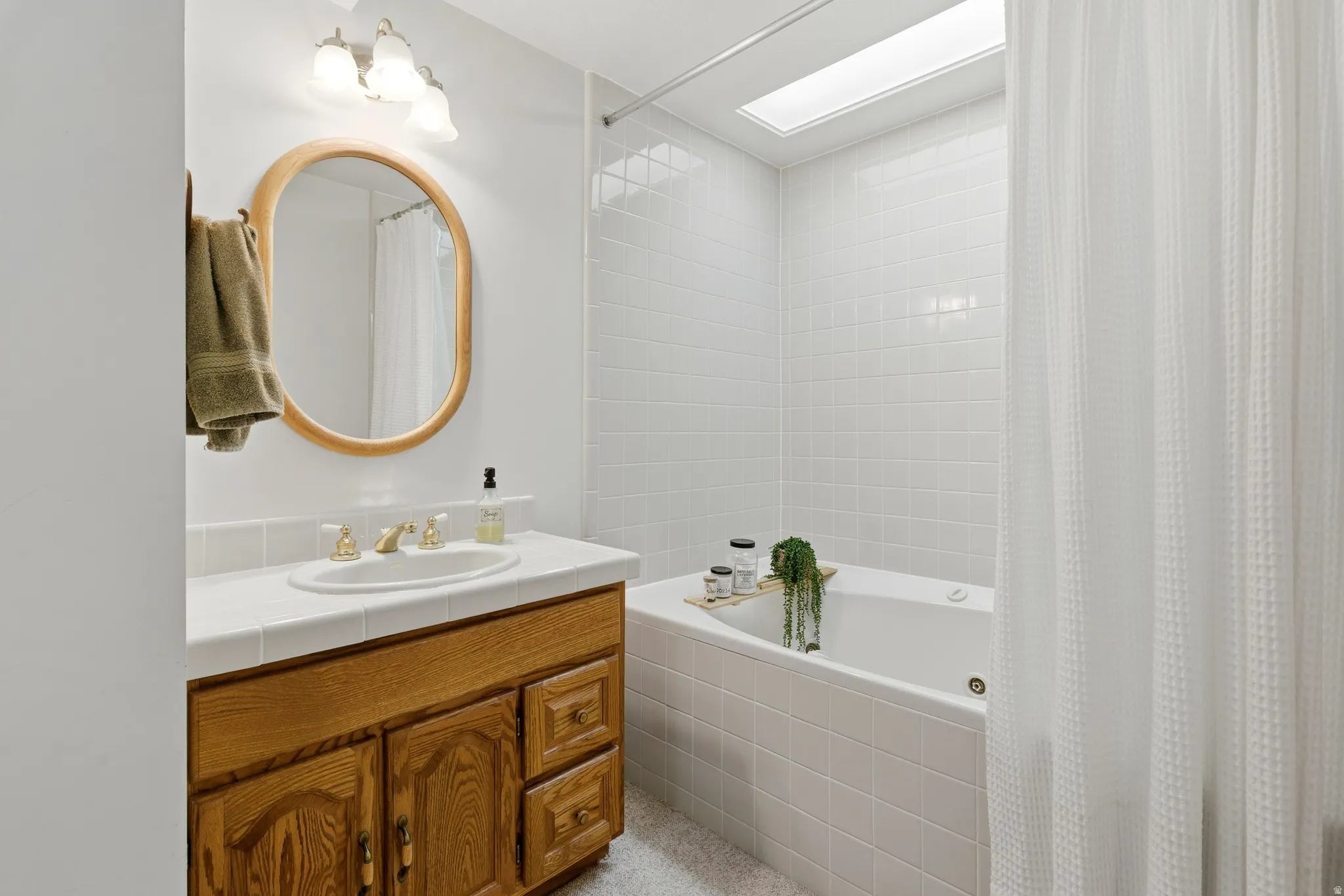 Full bath featuring vanity and tiled shower / bath