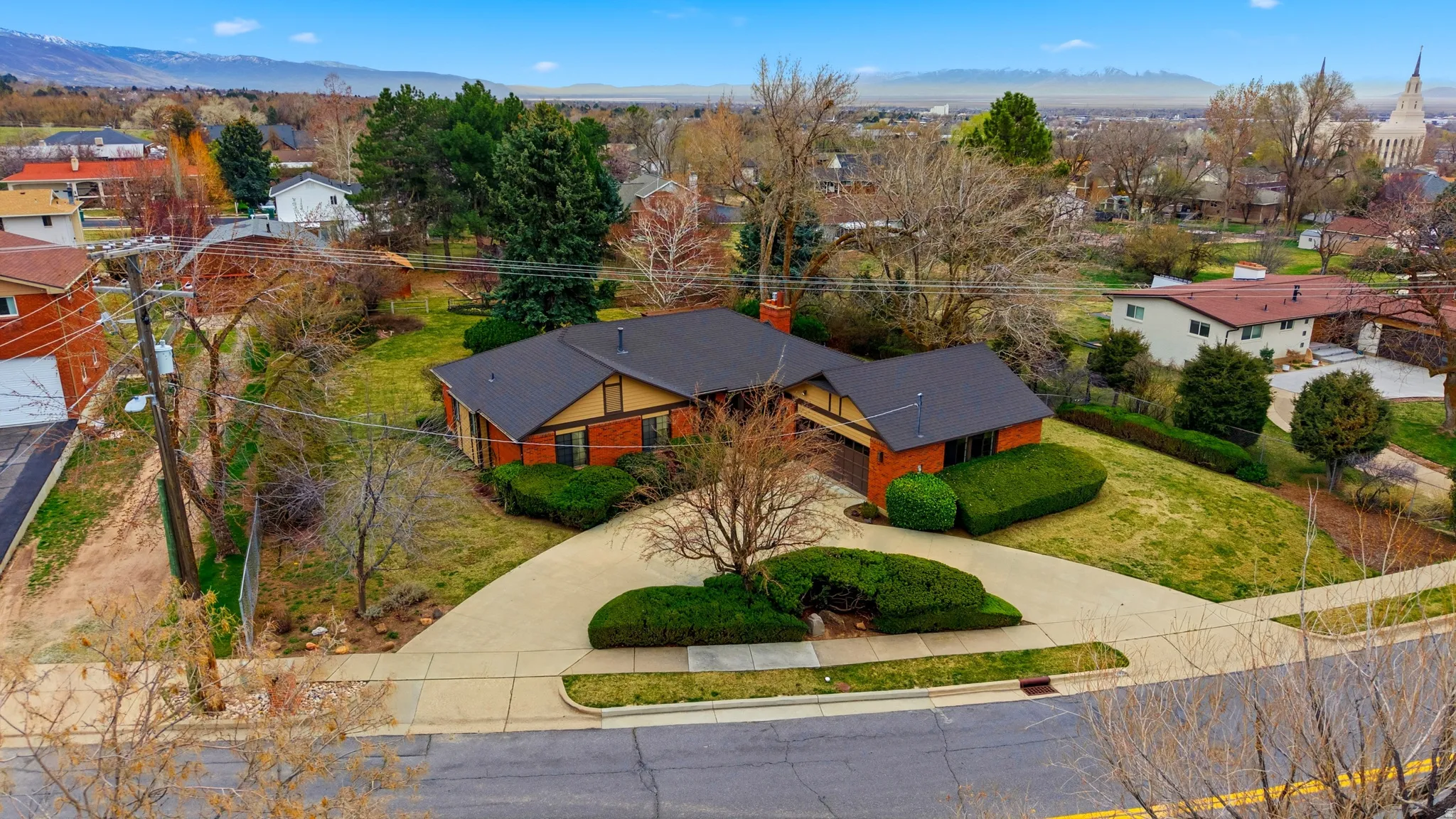 Aerial view of residential area featuring a mountainous background