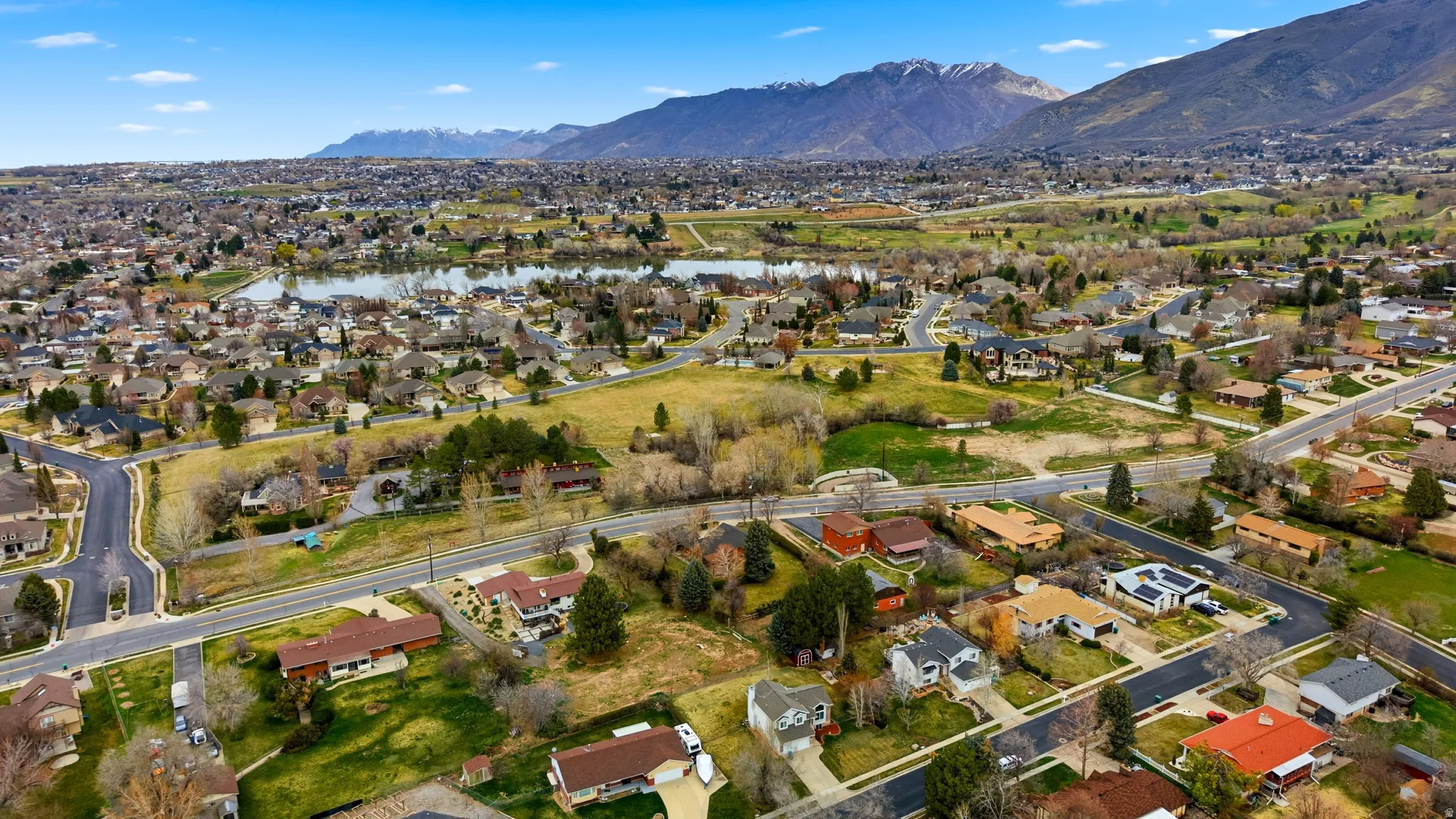 Aerial perspective of suburban area featuring a water and mountain view