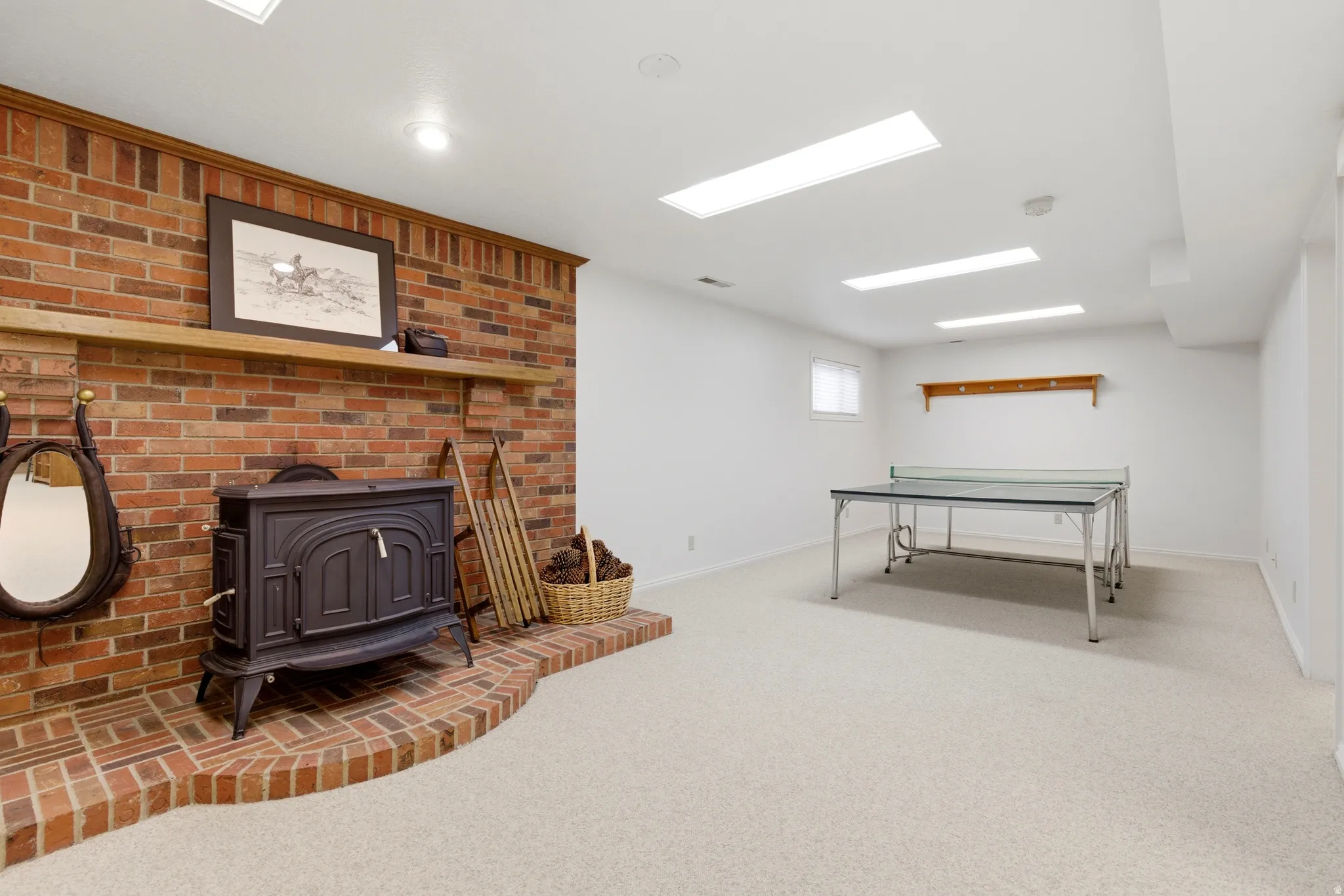 Playroom with a wood stove and light carpet