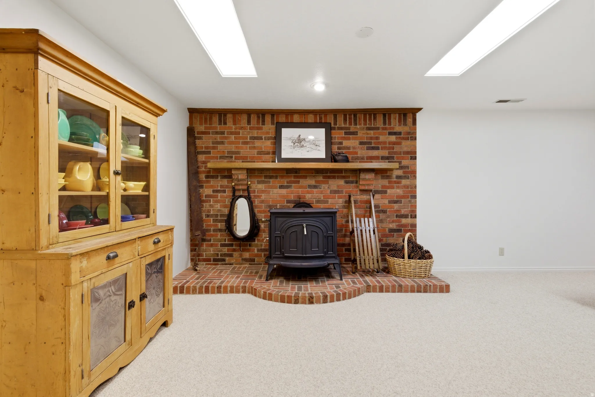 Living room featuring a wood stove and light carpet