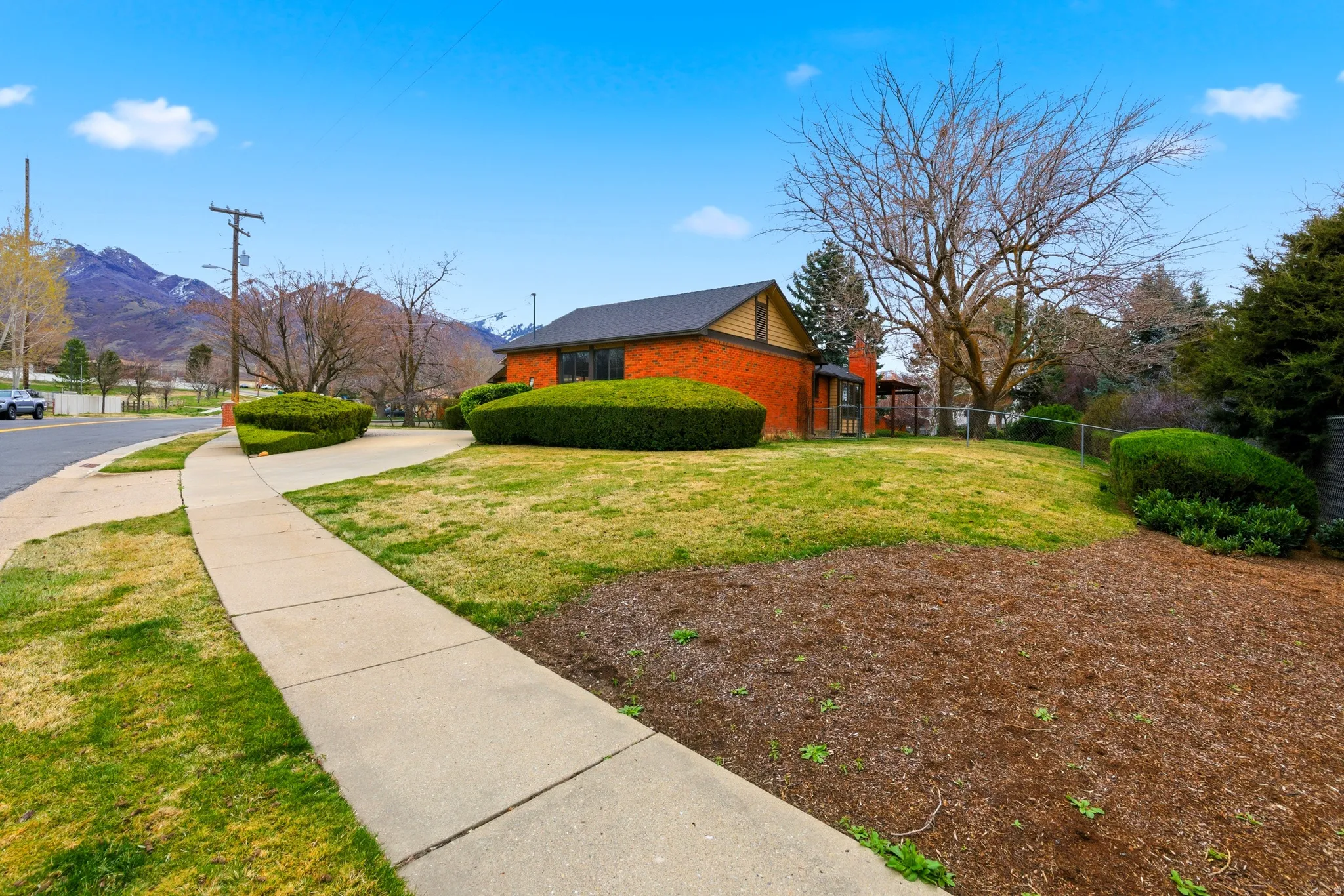 View of home's exterior featuring a mountain view and brick siding