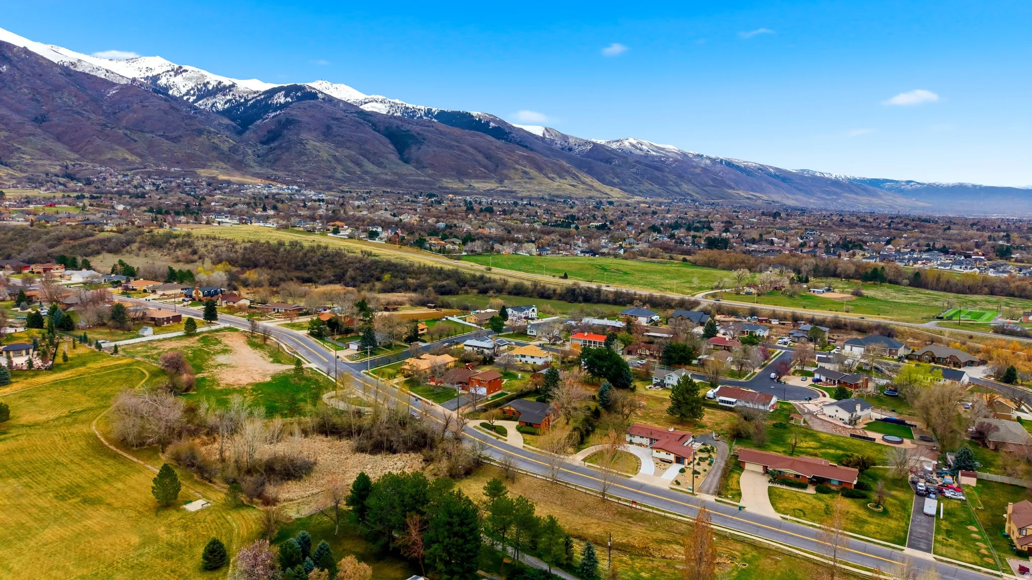 View of property location featuring mountains and nearby suburban area