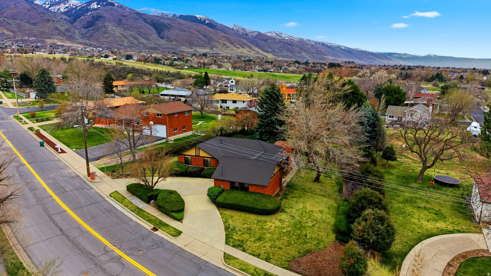 Aerial view of residential area featuring a mountainous background