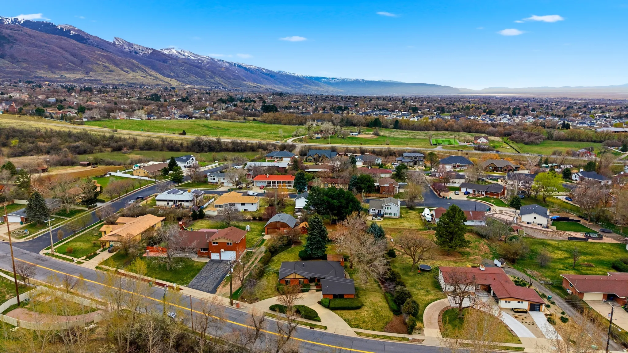 Aerial perspective of suburban area with a mountain backdrop