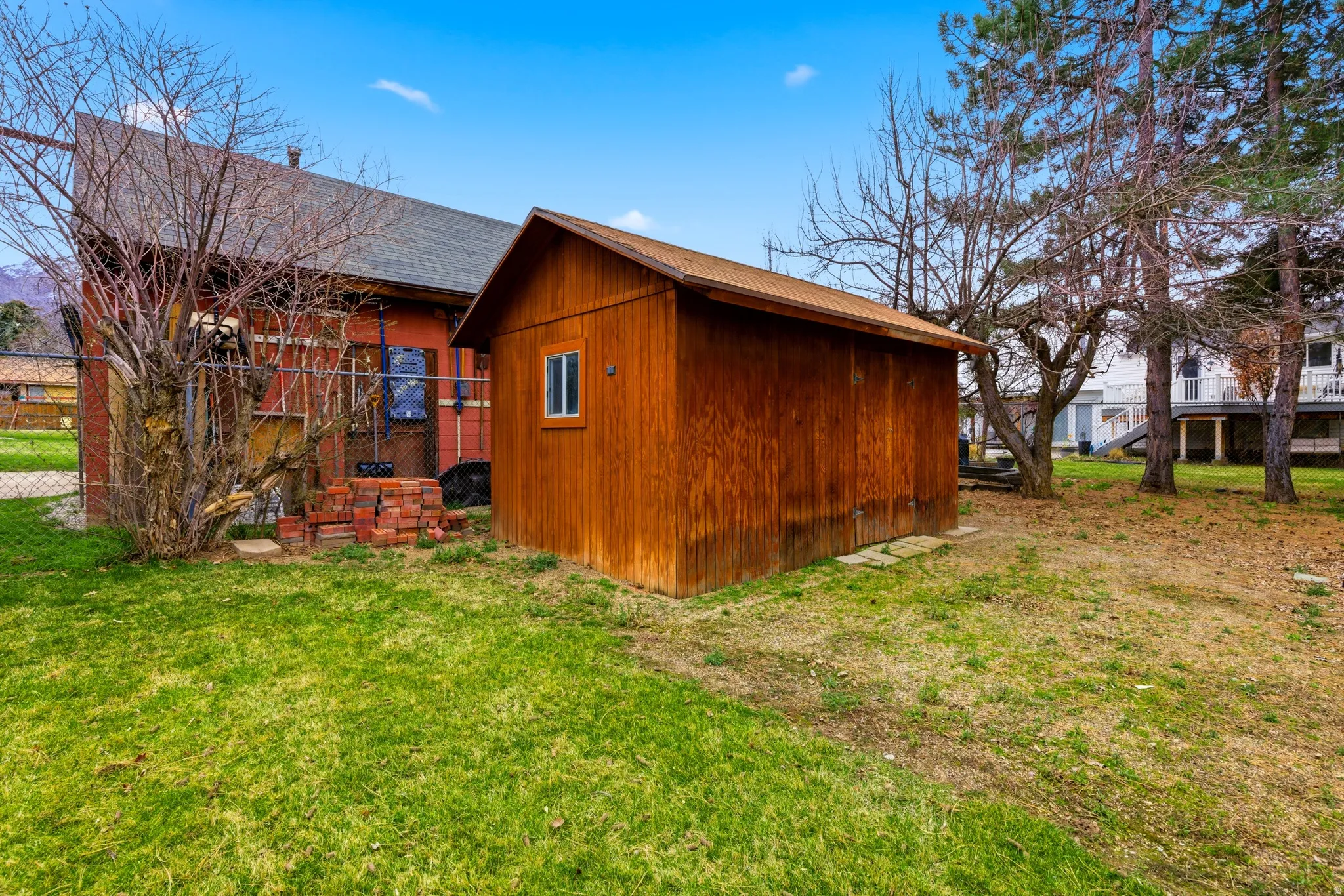 View of home's exterior with a lawn and a shingled roof