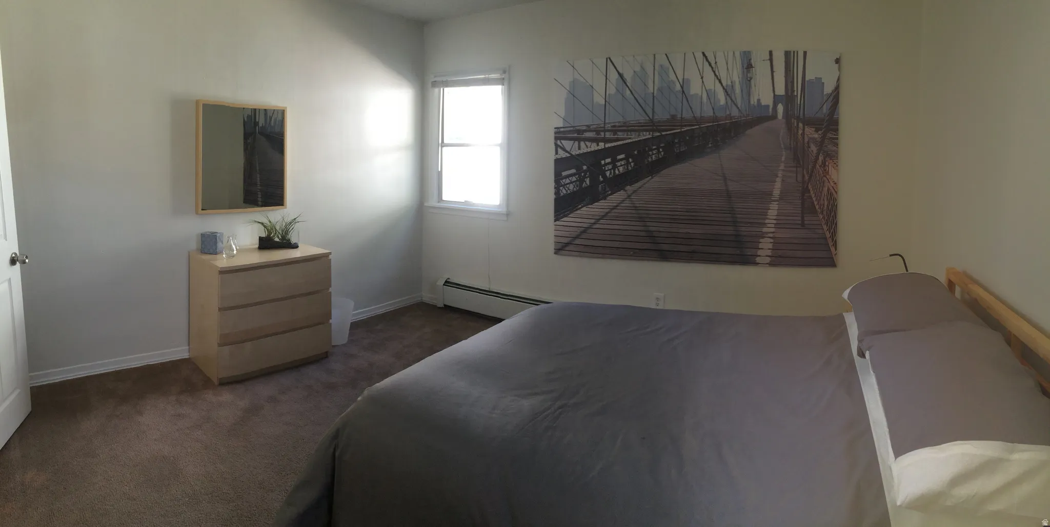 Bedroom featuring dark colored carpet and baseboard heating