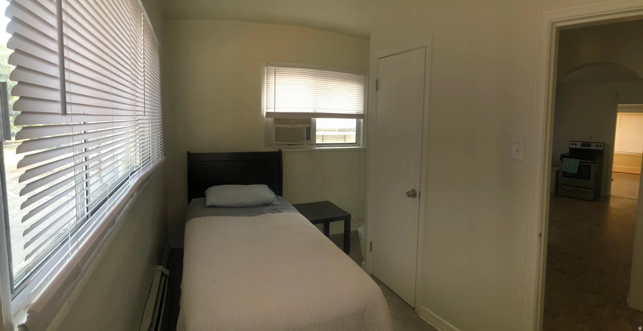 Bedroom with baseboard heating and cooling unit